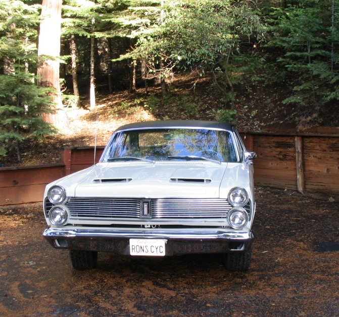 White 1966 Mercury Comet Cyclone front view with chrome grille and hood scoops