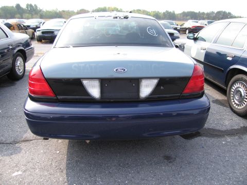 1991 Ford LTD Crown Victoria - Rear view of a 1991 Ford Crown Victoria LTD police car, showing 'STATE POLICE' text on the trunk lid.