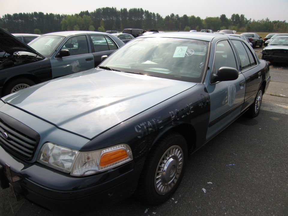 Police car, light blue and black, with "STATE POLICE 40" text, parked outdoors