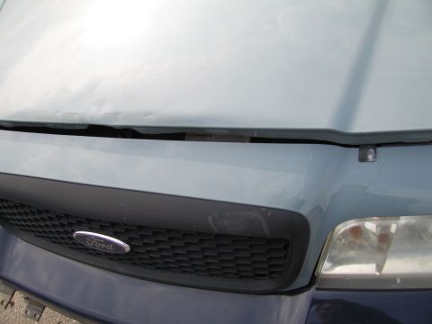 1991 Ford LTD Crown Victoria - Close-up of a Ford grille and hood, showing the vehicle's front end.