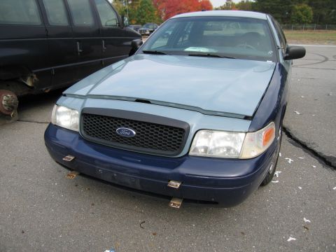 1991 Ford LTD Crown Victoria - Two-tone Ford Crown Victoria parked next to a black van.