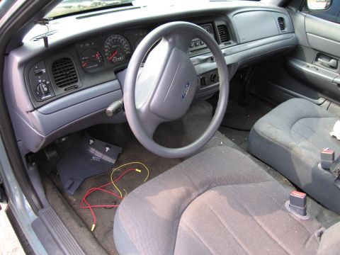 1991 Ford LTD Crown Victoria - Interior view of a 1991 Ford Crown Victoria LTD, the dashboard and seats. Loose wires are present on the floor.