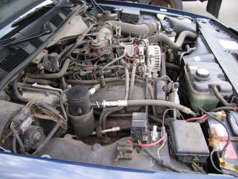 1991 Ford LTD Crown Victoria - The engine bay of a blue 1991 Ford Crown Victoria LTD is shown.