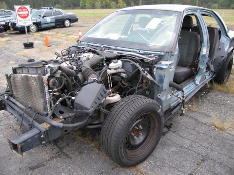 1991 Ford LTD Crown Victoria - Stripped 1991 Ford Crown Victoria LTD showing engine and chassis components. Front view.