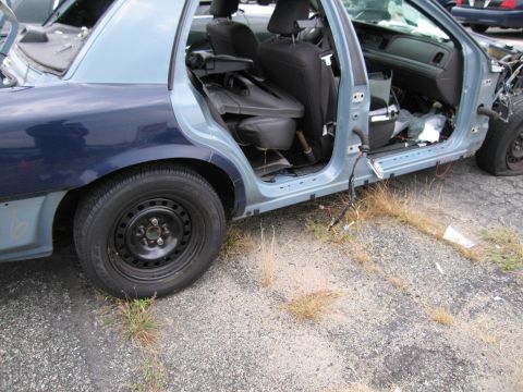 1991 Ford LTD Crown Victoria - This car is in a state of disrepair, with visible damage and missing parts.