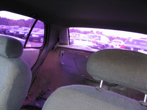 1991 Ford LTD Crown Victoria - Interior view of a 1991 Ford Crown Victoria LTD, seen from the back seat, with other vehicles visible outside.