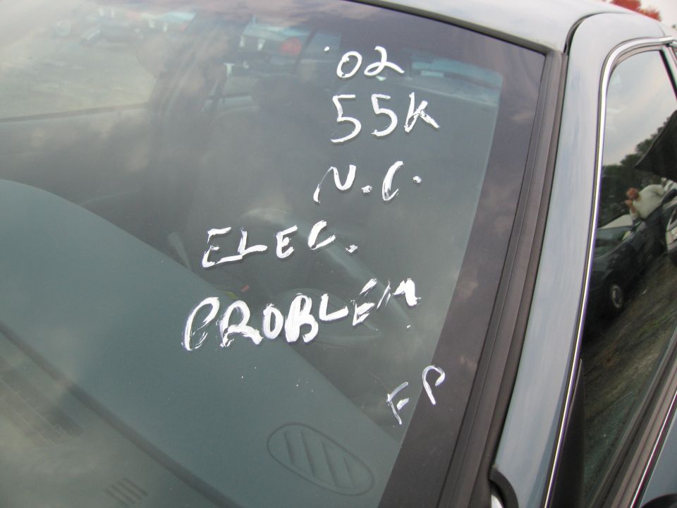 Windshield with handwritten notes: '02 55k N.C. ELEC. PROBLEM FP
