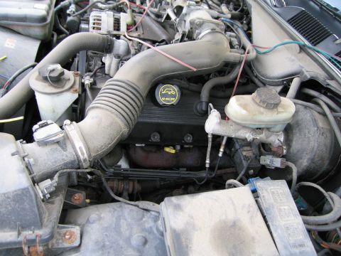 1991 Ford LTD Crown Victoria - Close-up view of a vehicle's engine bay, showing various components and wiring.