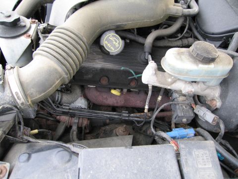 1991 Ford LTD Crown Victoria - Close-up of an engine bay, focusing on the air intake and brake fluid reservoir.