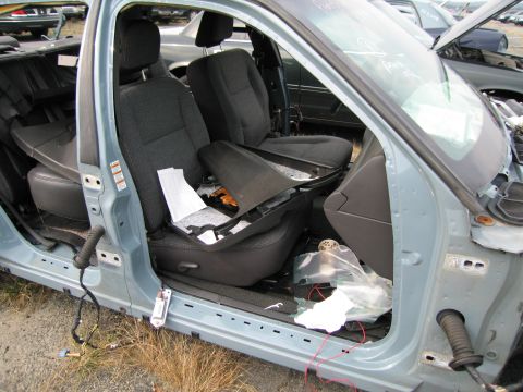 1991 Ford LTD Crown Victoria - Interior view of a light blue car showing damaged seats and wiring, likely in a junkyard.