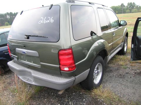 1991 Ford LTD Crown Victoria - This green Ford Explorer SUV is seen from the rear, with a number written on its window.
