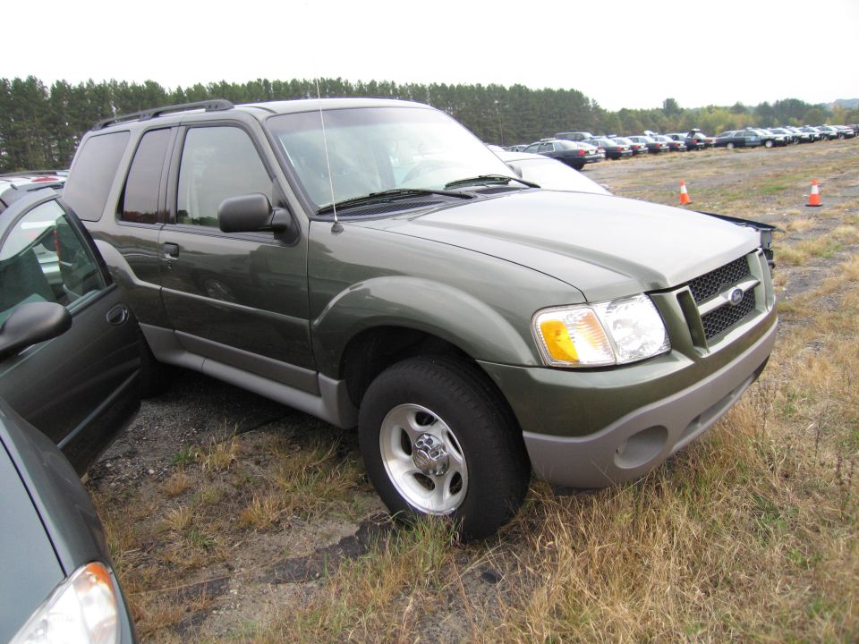 Green SUV parked next to another vehicle