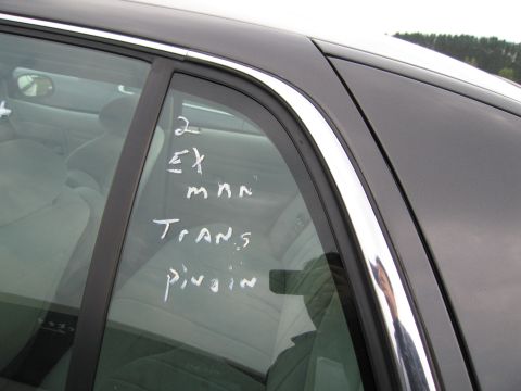 1991 Ford LTD Crown Victoria - Handwritten notes on a car's rear passenger window obscure any specific vehicle identification.