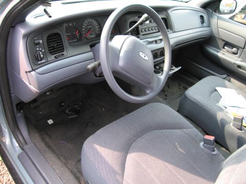 1991 Ford LTD Crown Victoria - Interior view of a car's dashboard, steering wheel, and front seats.