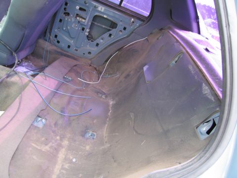 1991 Ford LTD Crown Victoria - Rear interior of a car, door panel removed, showing exposed wiring and insulation.