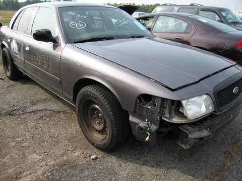 1991 Ford LTD Crown Victoria - Gray Ford Crown Victoria, possibly a 1996 model, with damage to the front end.
