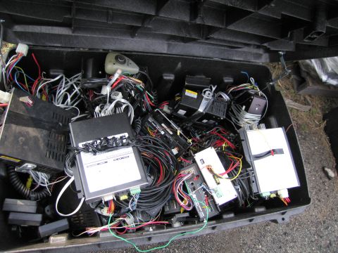 1991 Ford LTD Crown Victoria - A collection of electronic parts and wiring is stored inside a black case.