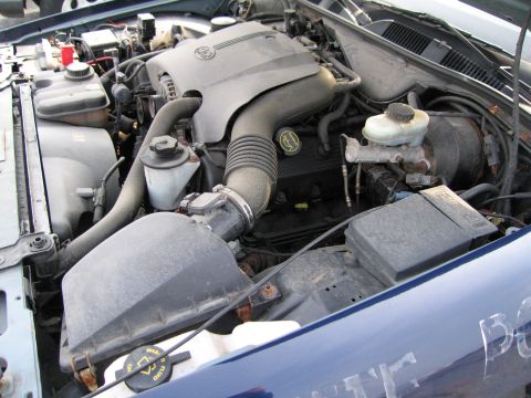 1991 Ford LTD Crown Victoria - Close-up view of the engine compartment, showing various components and hoses.