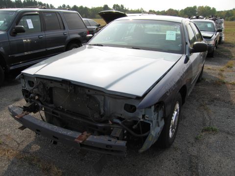 1991 Ford LTD Crown Victoria - Front view of a damaged 1991 Ford Crown Victoria LTD at a salvage yard.