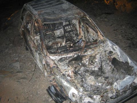 1994 Ford Bronco - This heavily damaged vehicle shows extensive fire damage to its interior and engine compartment.
