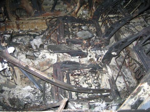 1994 Ford Bronco - The interior of this vehicle is severely damaged, with seats and other components appearing melted and burnt.