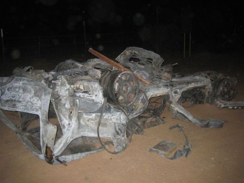 1994 Ford Bronco - The remains of a vehicle after a fire, showing extensive damage to the body and interior.