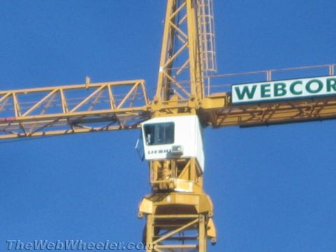 1968 Ford Mustang - A yellow construction crane with a white operator's cab is visible against a clear blue sky, a prominent "Webcor" sign.