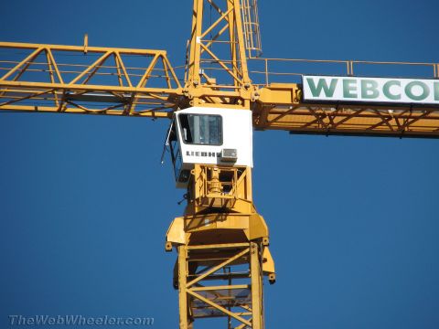 1968 Ford Mustang - Construction crane cab with "WEBCO" signage against a clear blue sky.