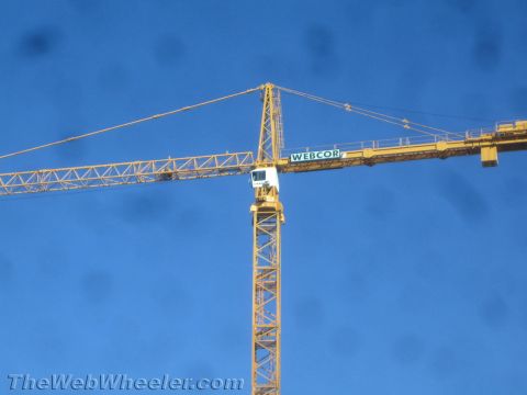 1968 Ford Mustang - A large yellow construction crane is shown against a clear blue sky. The crane has the name 'WEBCOR' visible on its boom.