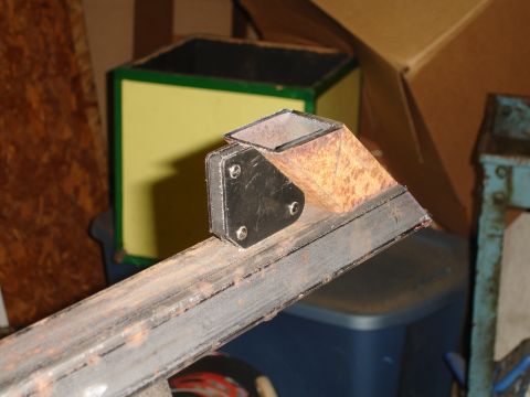 1989 Ford Bronco - Close-up of a rusty metal bracket assembly on a square tube frame.