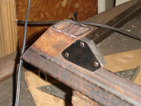 1989 Ford Bronco - Close-up of a metal fabrication project, showing a welding jig on rusty tubing.