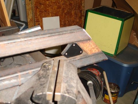 1989 Ford Bronco - A close-up view of a metal bracket with a triangular sensor, likely a part for a vehicle.