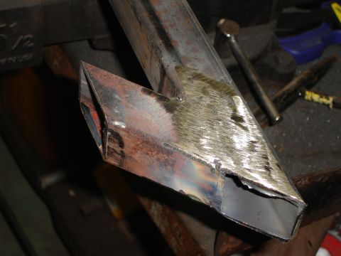 1989 Ford Bronco - A close-up view of a metal tube with a custom angled cut, showing signs of recent welding and fabrication work.