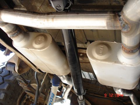 1979 Ford Bronco - The exhaust system and suspension components are visible from underneath the vehicle.
