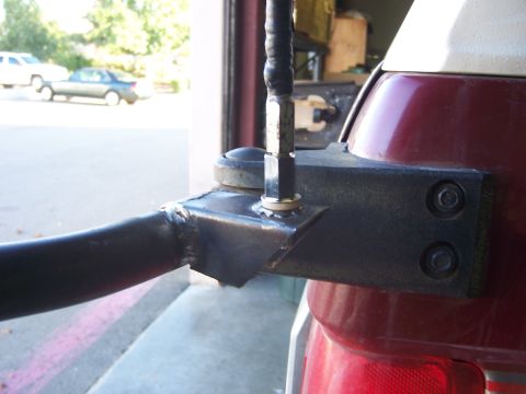 1991 Ford Bronco - A custom metal bracket is bolted to the rear of a vehicle to hold a CB radio antenna.