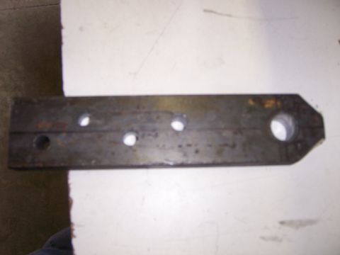 1991 Ford Bronco - A fabricated metal part, possibly a bracket or linkage, with four drilled holes and a tapered end is shown.