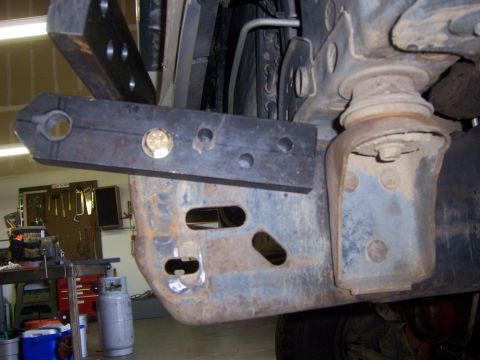 1991 Ford Bronco - Detail of custom metalwork being attached to the front bumper structure of a vehicle.