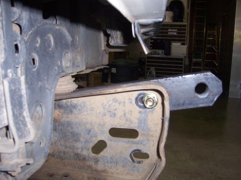 1991 Ford Bronco - A custom metal bracket is bolted to the chassis of a vehicle, likely for bumper modification.