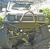 1968 Ford Mustang - This Suzuki Samurai is navigating a challenging off-road course.