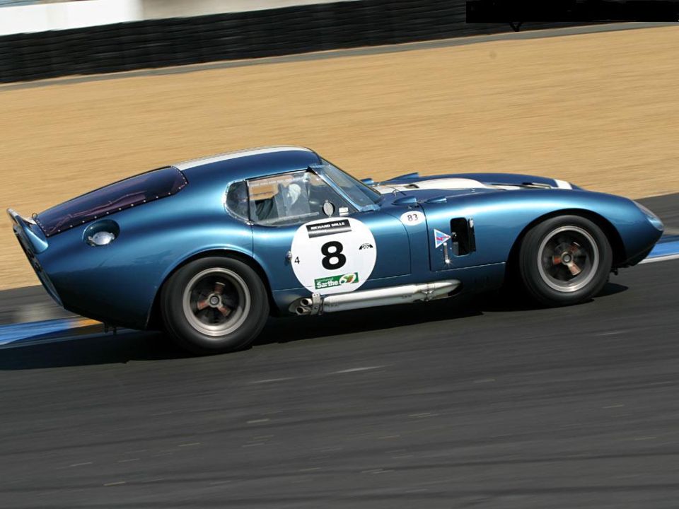Blue racing car with white stripes and number 8 on a circular decal. Side exhaust pipes visible