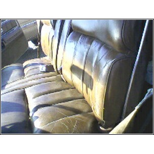 1973 Ford Ranchero - Interior view of a brown leather bench seat with seatbelts in a vehicle.