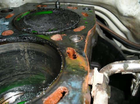 1986 Toyota Hilux - This image shows a severely damaged engine cylinder head, indicating a gasket failure and coolant leakage.