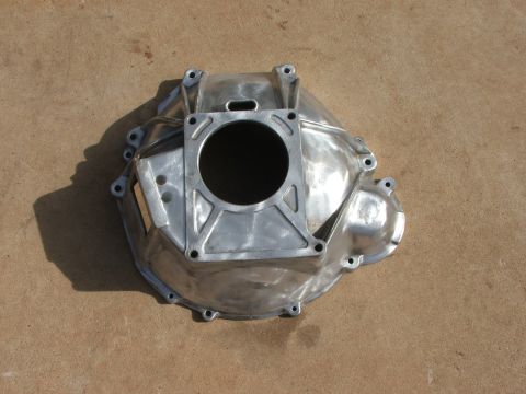 1965 Ford Mustang - Aluminum bell housing part shown from above on a concrete surface.