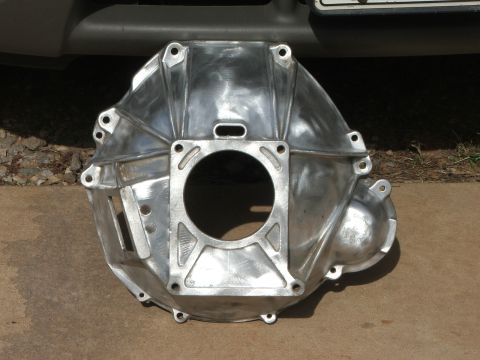 1965 Ford Mustang - This aluminum bellhousing is shown from the front, with a central circular opening and surrounding bolt mounting points.
