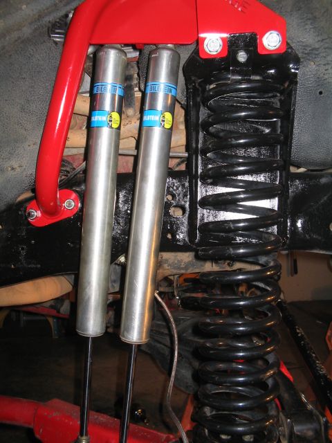 1989 Ford Bronco - Close-up view of aftermarket suspension components, including Bilstein shocks and coil springs.