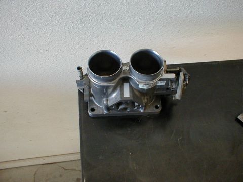 1996 Ford Bronco - A dual throttle body part is shown, likely an upgrade for a vehicle's engine system.