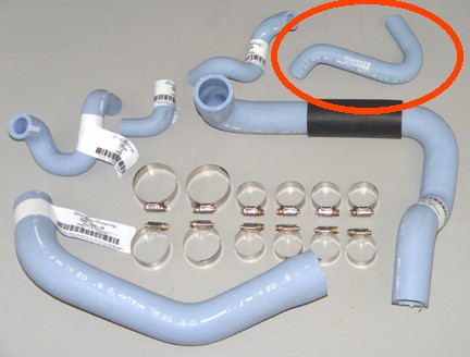 1993 Ford Mustang - A collection of radiator hoses and hose clamps are laid out on a flat surface.