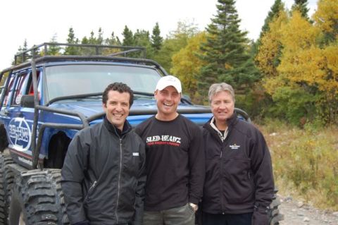 1996 Ford Bronco - Three men pose for a photo in front of a custom-built off-road vehicle during an outdoor excursion.