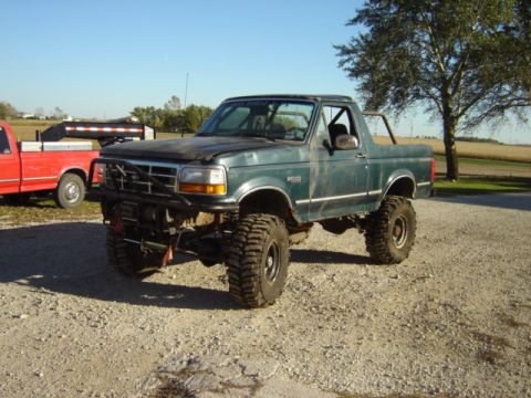 1992 Ford Bronco - This lifted 1992 Ford Bronco features an aggressive off-road stance with a custom front bumper and winch, ready for adventure.