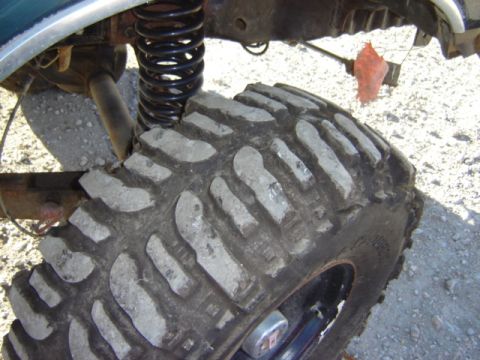 1992 Ford Bronco - Detail shot of a vehicle's tire and suspension system, likely for off-road use.